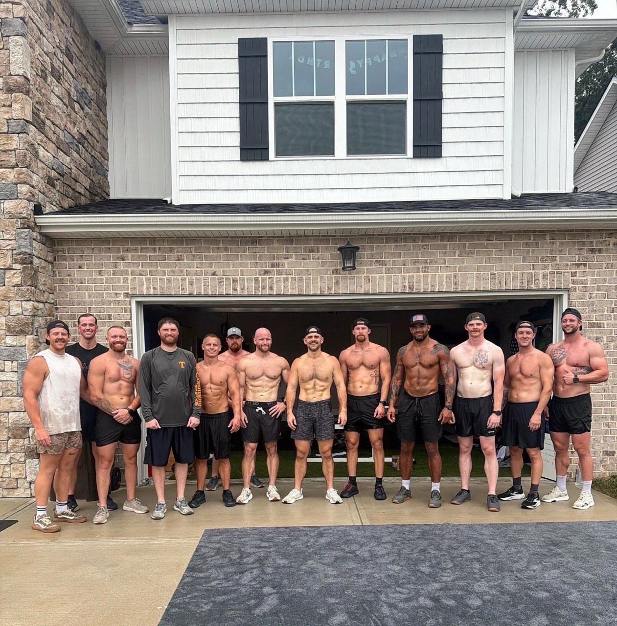 The group lined up in front of the open garage after a Saturday workout